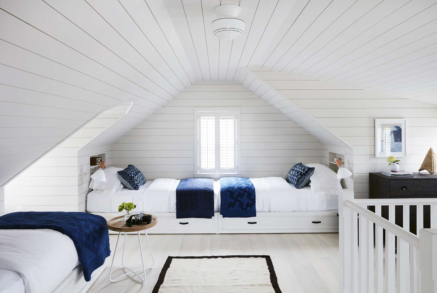 White Attic Bedroom with Twin Beds and Blue Accents