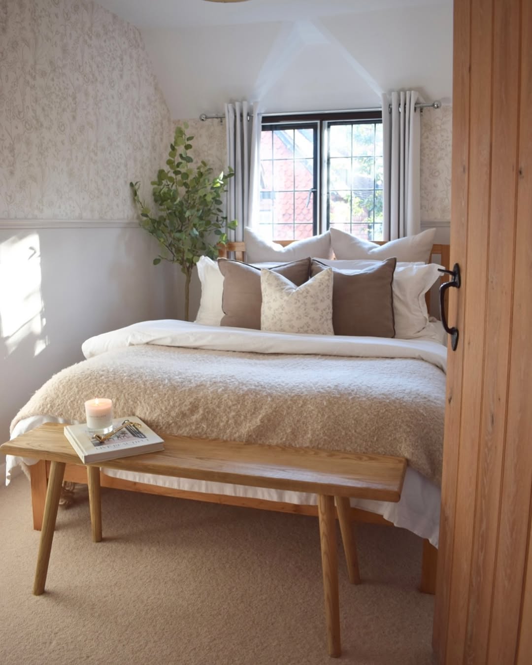 Cozy bedroom with earth tones and botanical wallpaper