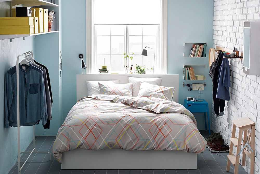 Light Blue Bedroom with Patterned Bedding and Functional Storage