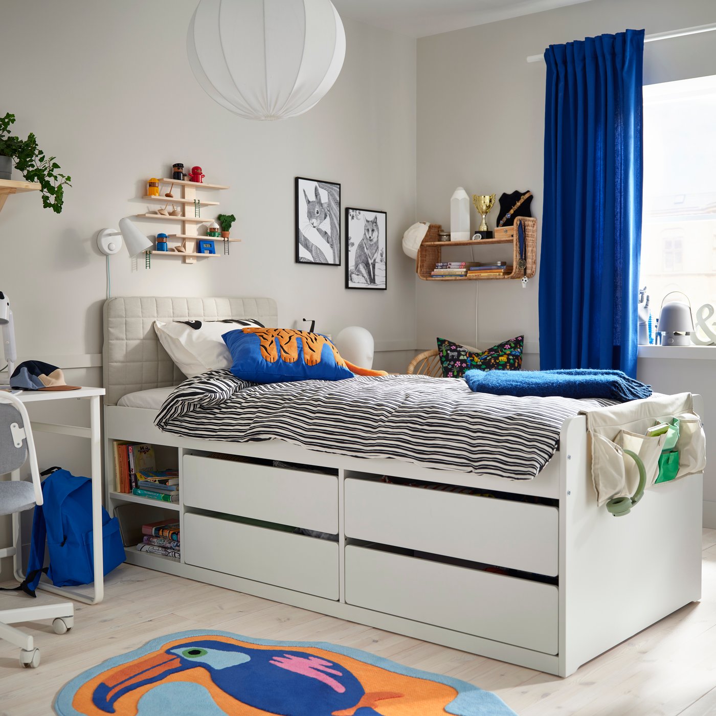 Kids' bedroom with white storage bed and blue accents