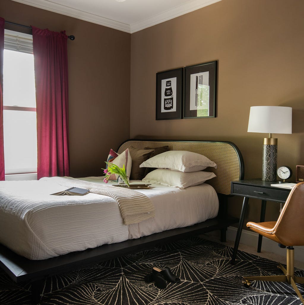 Cozy Brown Bedroom with Cane Headboard and Graphic Rug