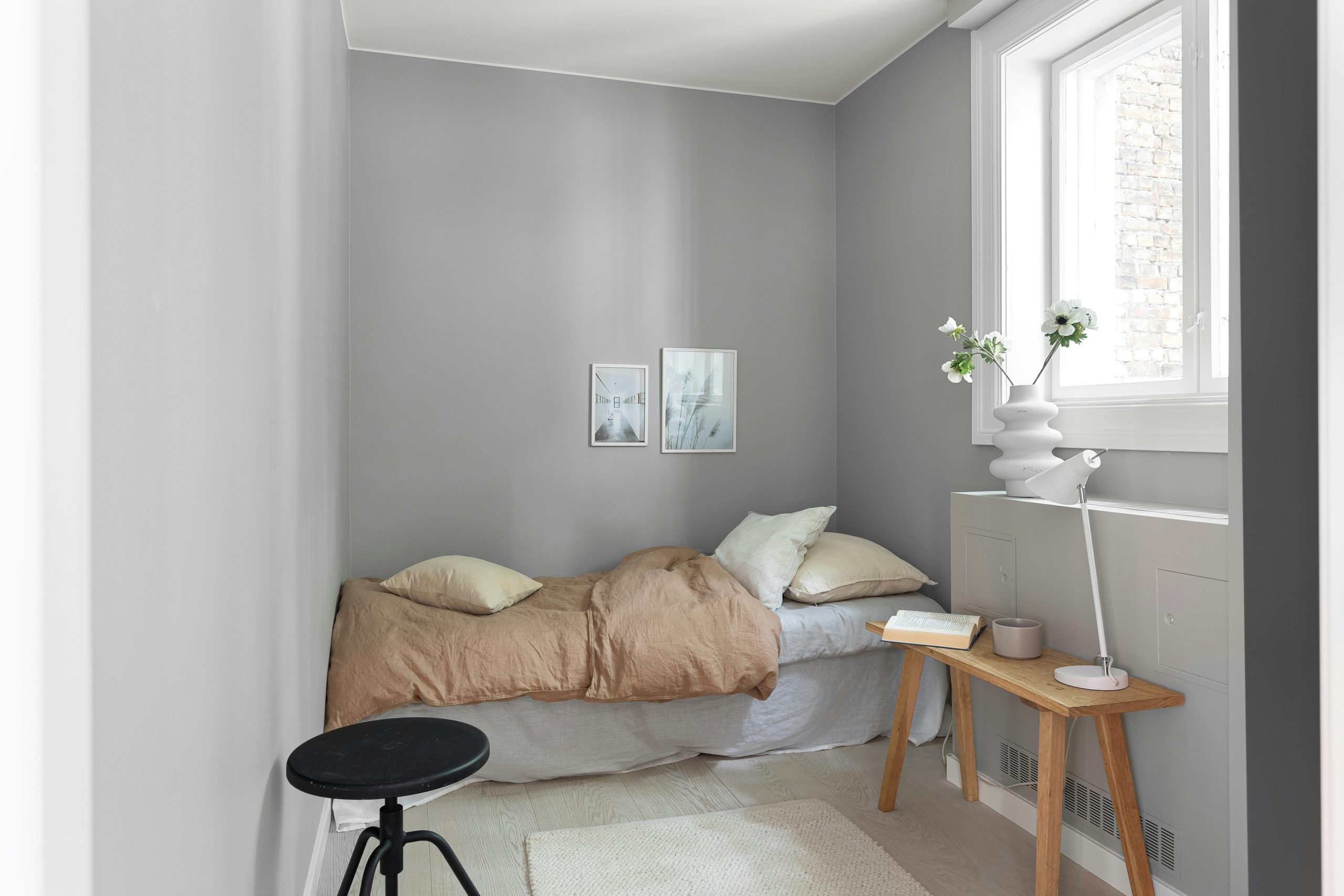 Cozy minimal bedroom with neutral tones and natural wood accents