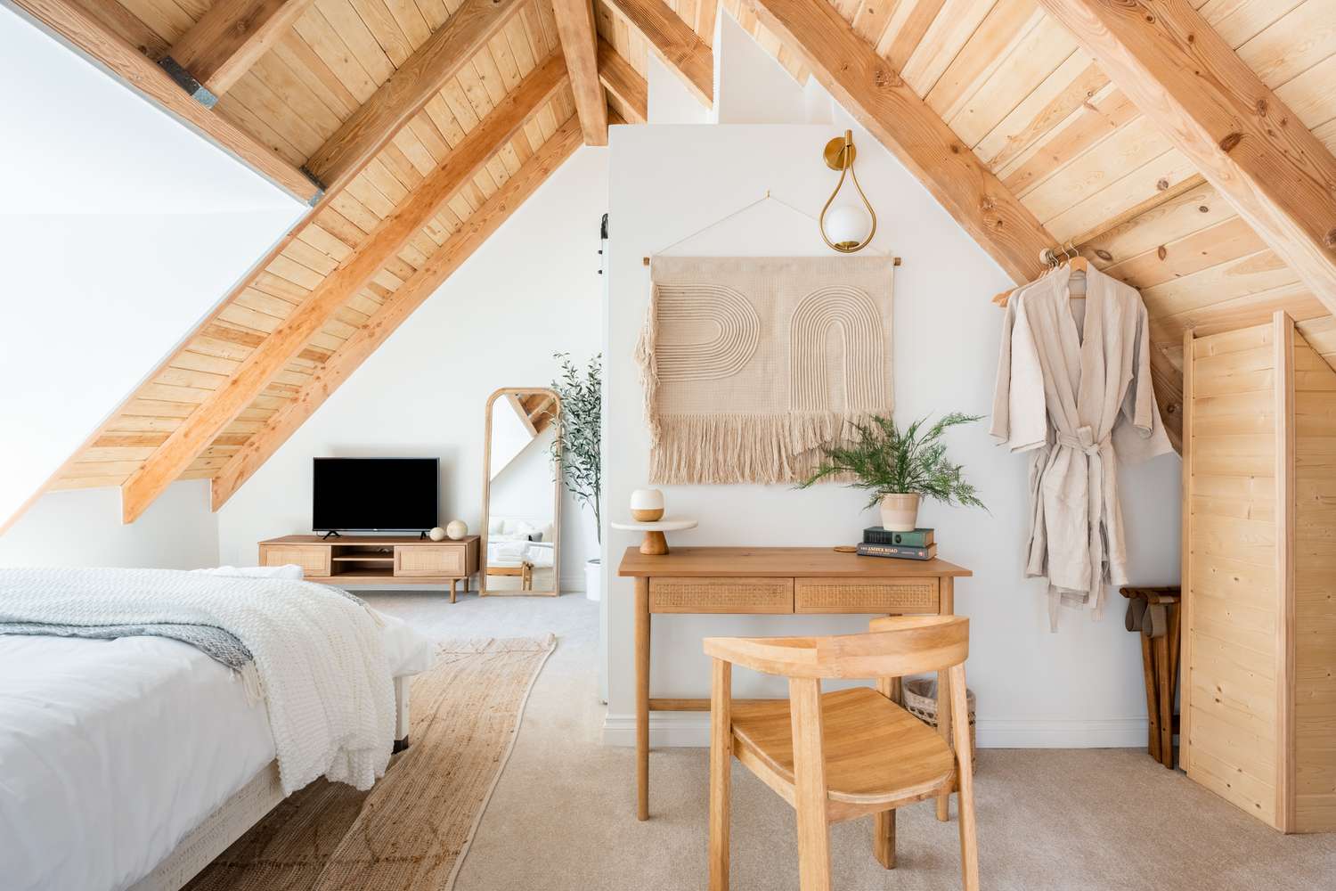Cozy Attic Bedroom with Natural Wood Slanted Ceiling and Neutral Decor