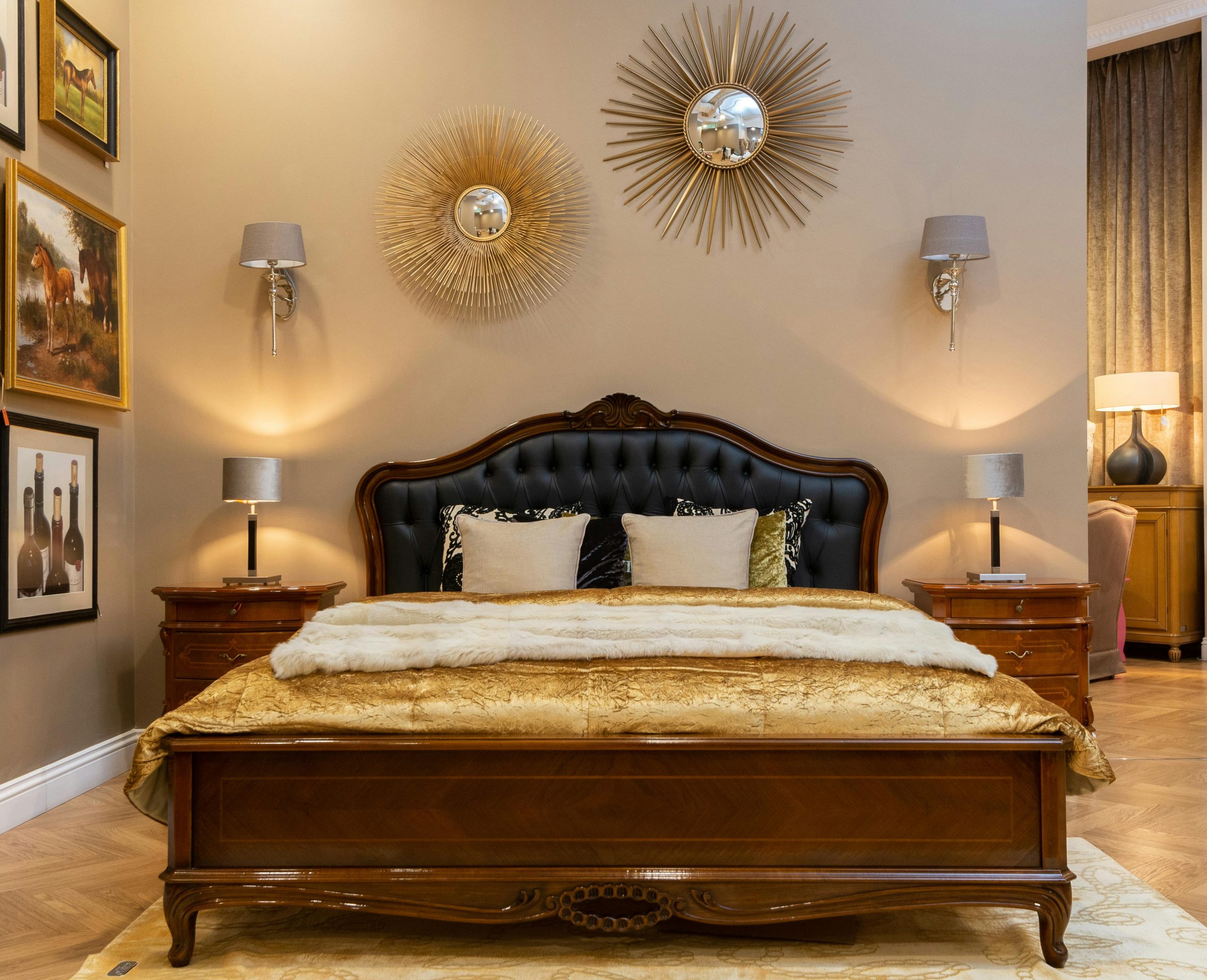 Regal Bedroom with Ornate Wooden Bed and Gold Sunburst Mirrors