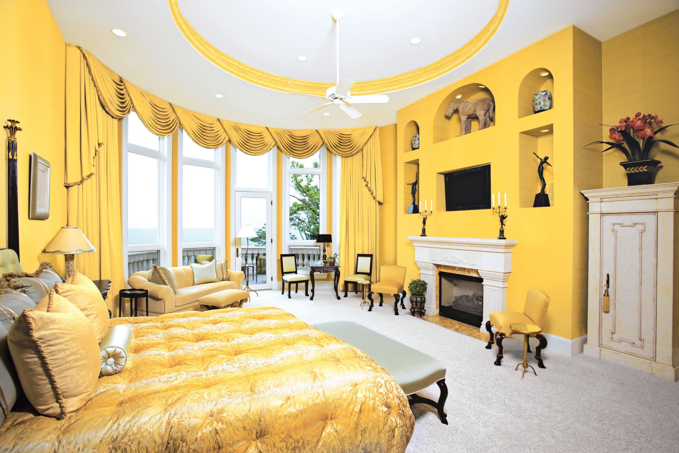 Opulent Yellow Bedroom with Fireplace and Ocean View