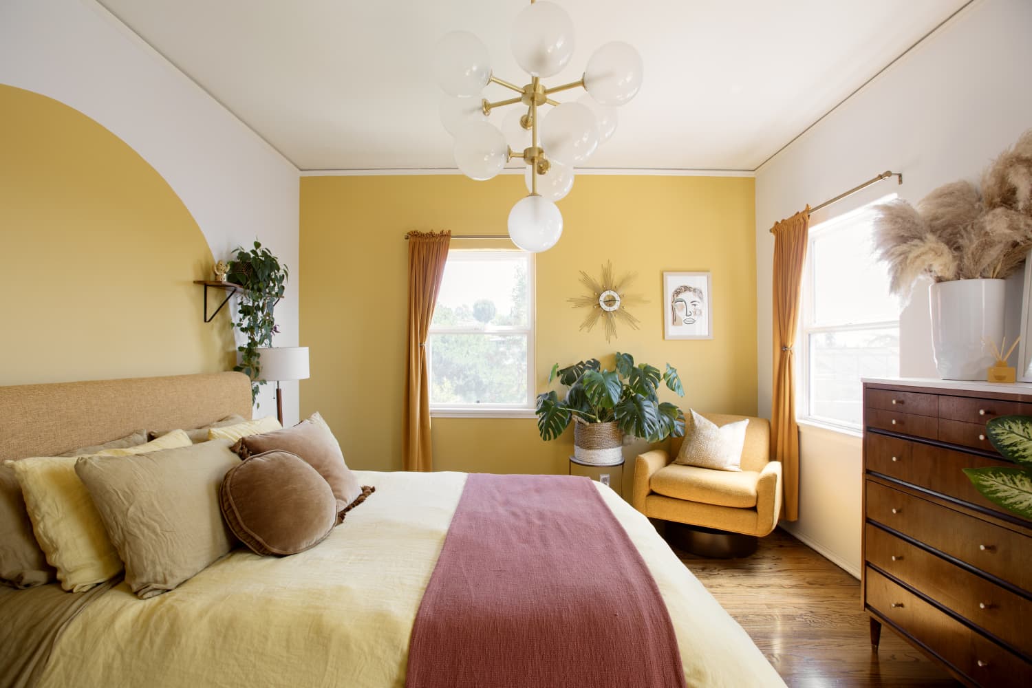 Warm Yellow Bedroom with Mid-Century Furniture and Globe Chandelier