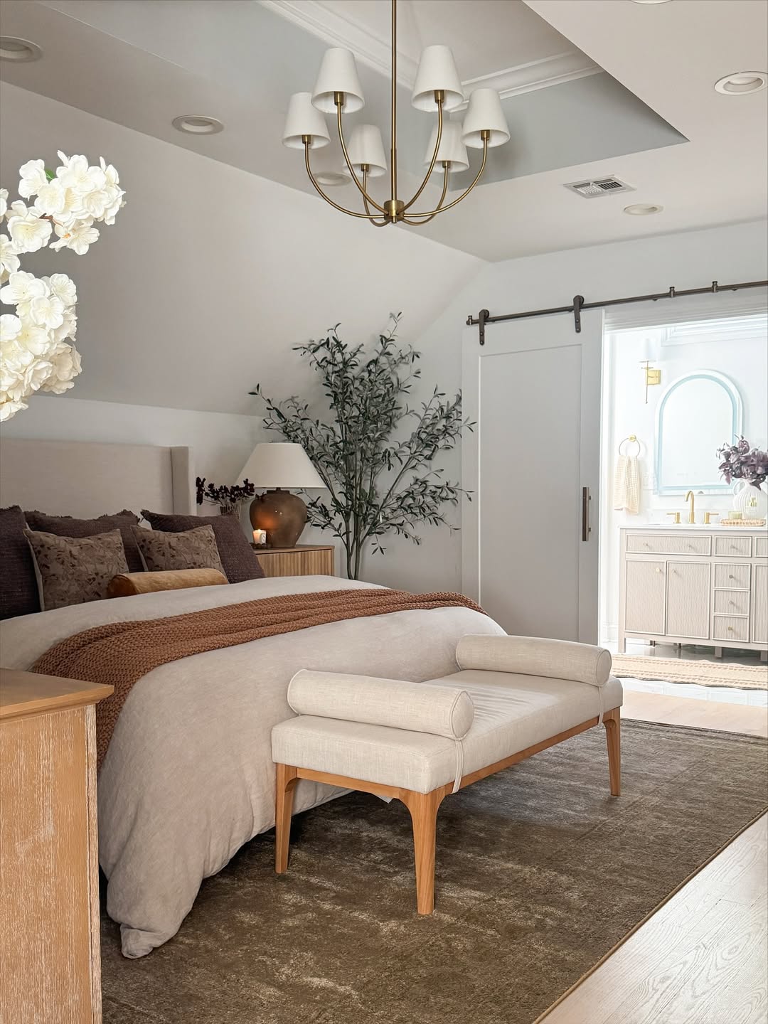 Neutral Bedroom with Rust Accents and White Barn Door
