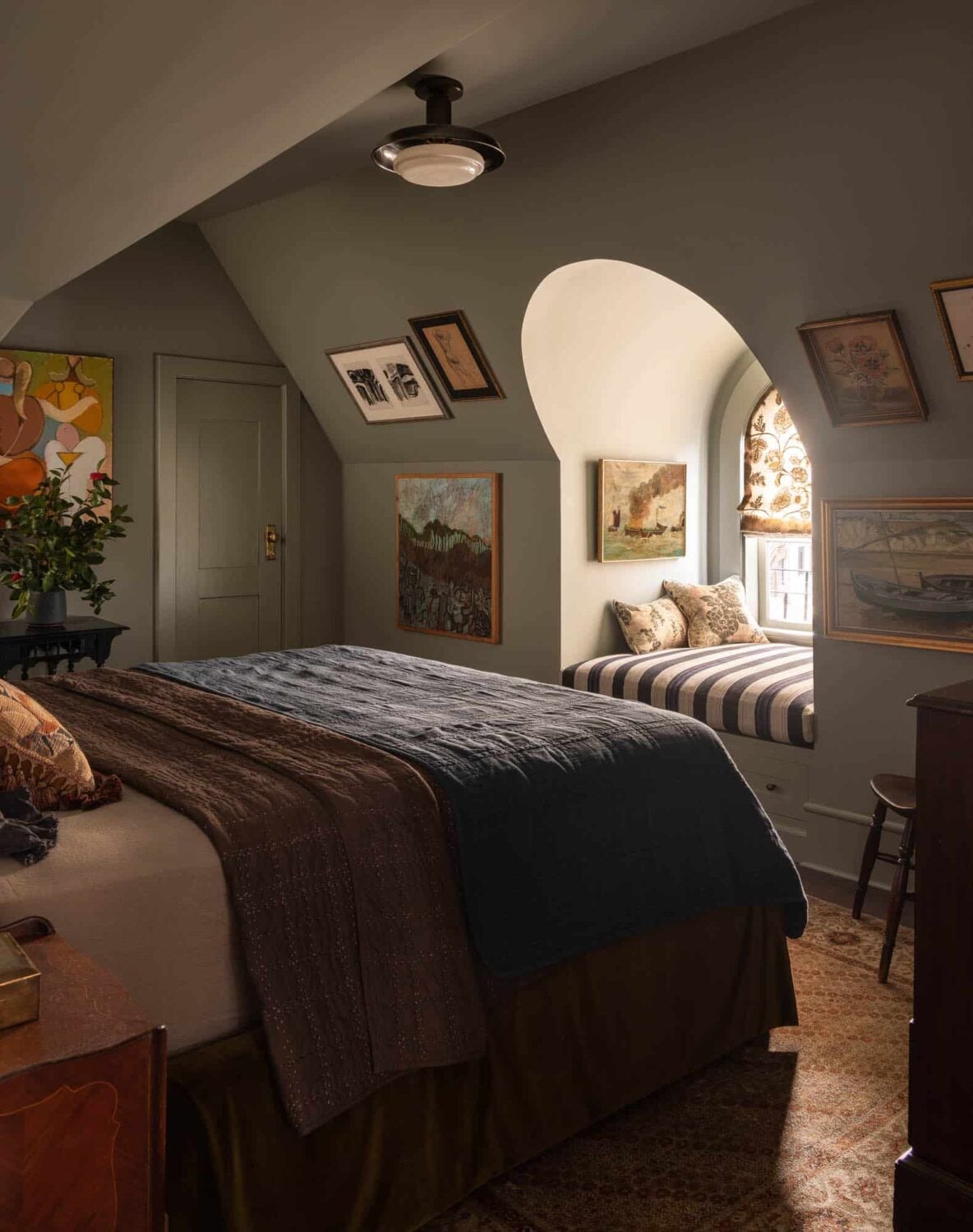 Cozy Attic Retreat with Olive Walls and Gallery Art