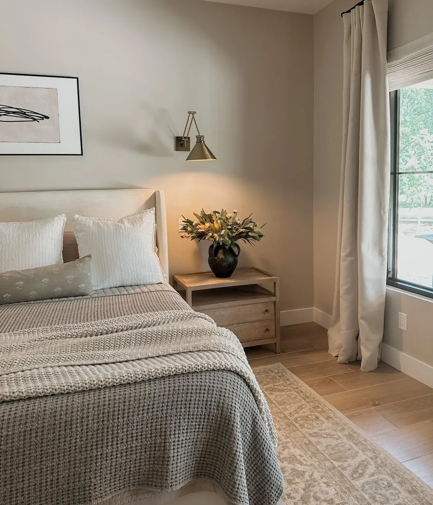 Neutral Bedroom with Layered Greys and Brass Sconce