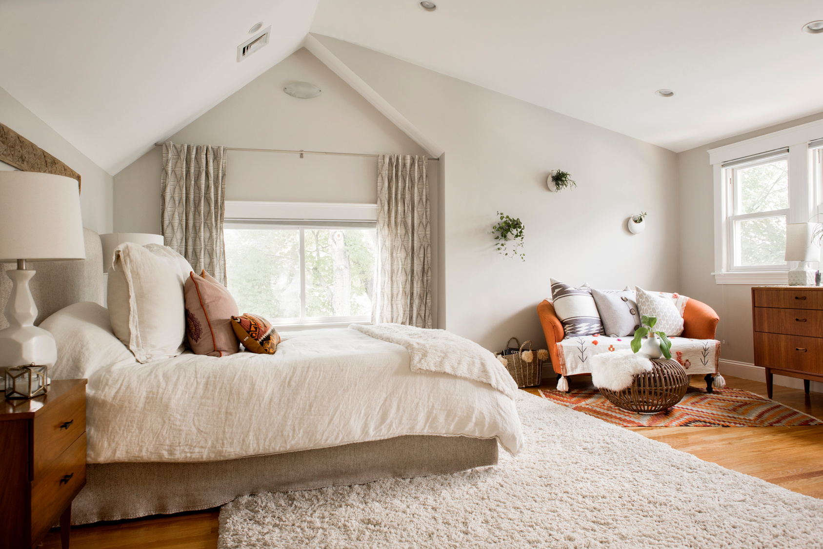 Cozy Attic Bedroom with Cream, Wood, and Orange Accents