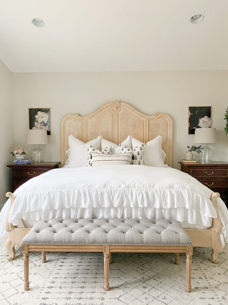 11. Carved Wood Bed with Ruffled White Bedding
