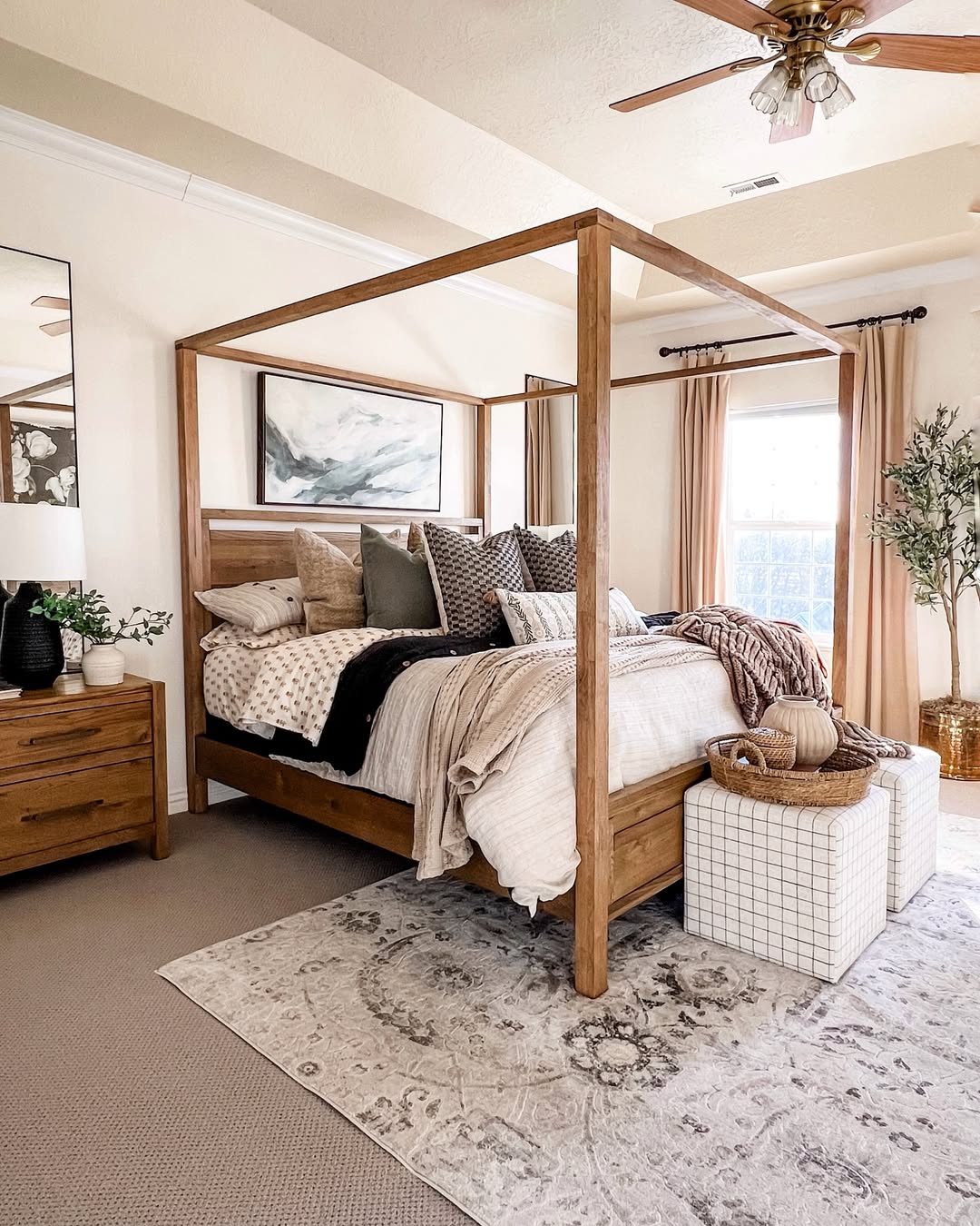 6. Cozy Canopy Bed with Layered Neutrals and Medallion Rug