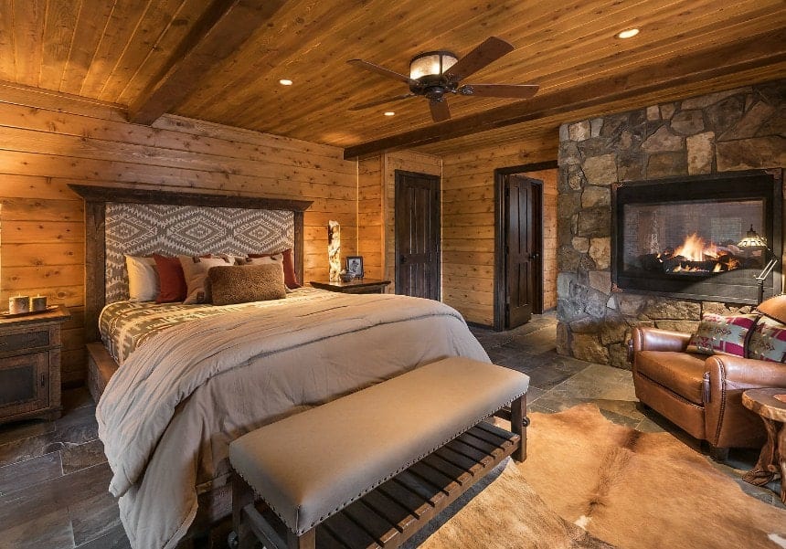 7. Wood and Stone Cabin Retreat with Geometric Headboard